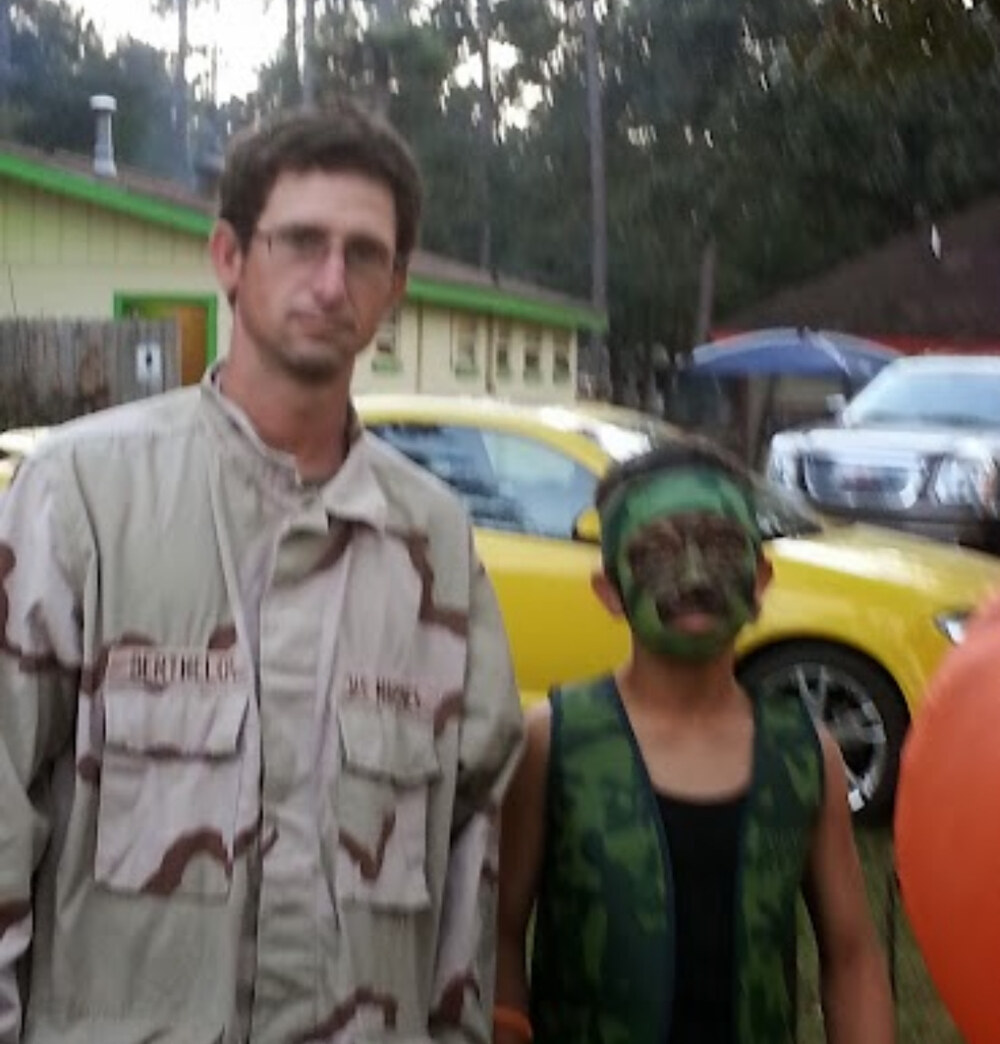 Brandon standing with Tristin in costume